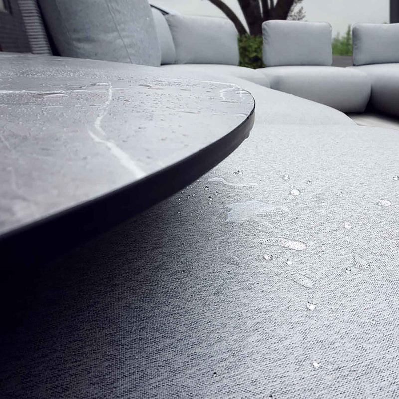 A close-up of an aluminum upholstered ottoman with grey frame and grey fabric set against a white background. Outdoor furniture, outdoor balcony furniture, outdoor lounge chair.