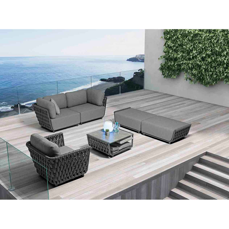 Dark-grey Lawson 5-seater outdoor rope modular lounge with matching coffee table, set on a sleek wooden deck of a modern house overlooking the ocean, creating a stylish and relaxing outdoor living space.