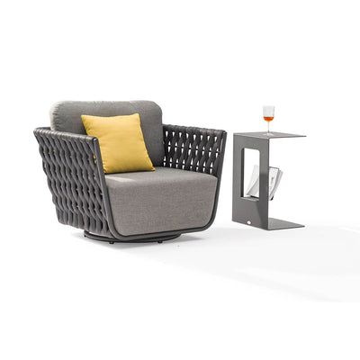 Dark grey Lawson outdoor rope swivel chair with a yellow pillow, paired with an aluminium side table holding a drink, set against a plain white backgroundperfect for enhancing outdoor living with style and comfort.