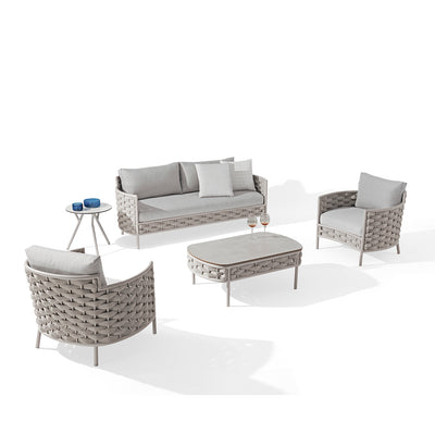 Boston Outdoor Rope Coffee Table with two wine glasses and a rolled-up magazine on it, surrounded by two Boston Outdoor Rope Armchairs and a Boston 2-Seater Outdoor Rope Lounge, all in beige, set against a plain white background, exemplifying elegant alfresco furniture.