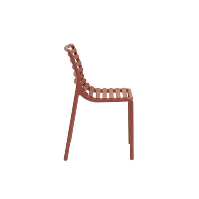 Red resin Nardi Doga outdoor dining chair, perfect for alfresco furniture setups, displayed on a plain white background, viewed from the side.