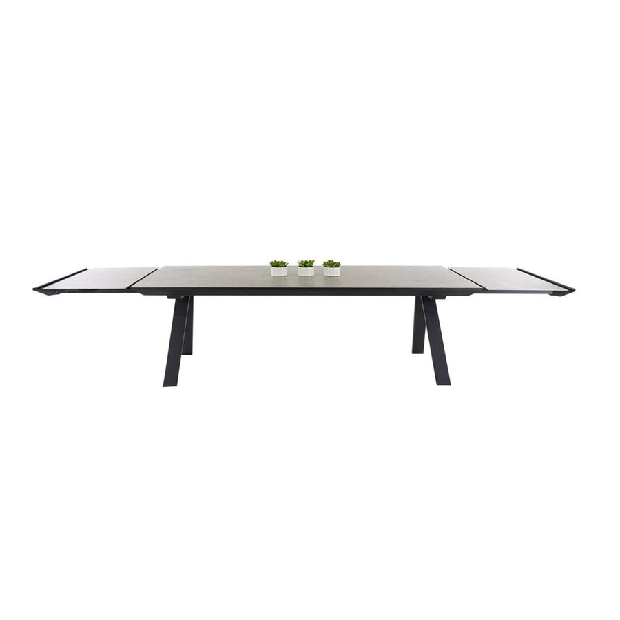 Brown, rectangular Neverland extendable ceramic outdoor table with 3 small pot plants, perfect for alfresco furniture setups, displayed on a plain white background, viewed from the front.