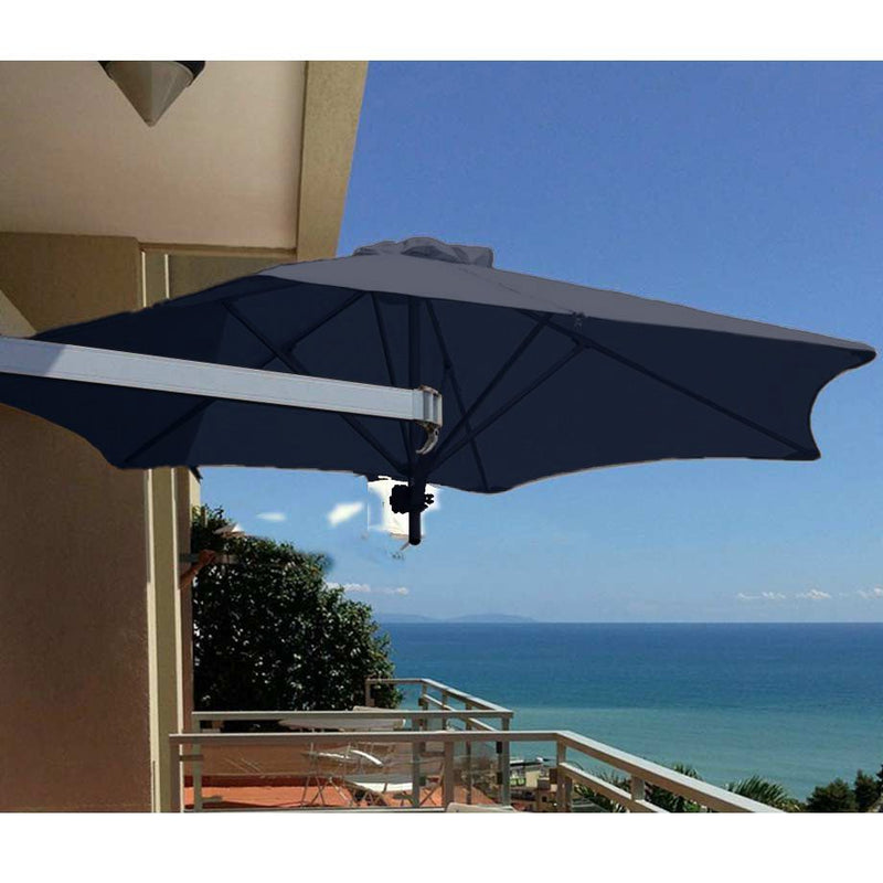 Dark-colored outdoor umbrella wall-mounted on a balcony, with a view of the seaside and sunlight in the background, providing shade and enhancing the outdoor living space.