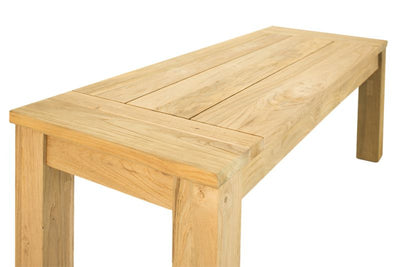 The Polly light-brown 110 cm teak outdoor bench, one of Remarkable Outdoor Living's best pieces of outdoor furniture, is displayed on a plain white background and viewed from a side angle.