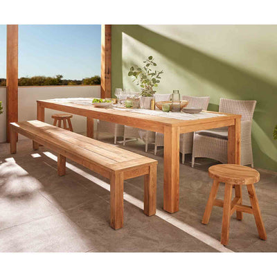 Outdoor furniture: Polly dining table made from FSC-certified recycled teak, natural finish, set against a green wall.