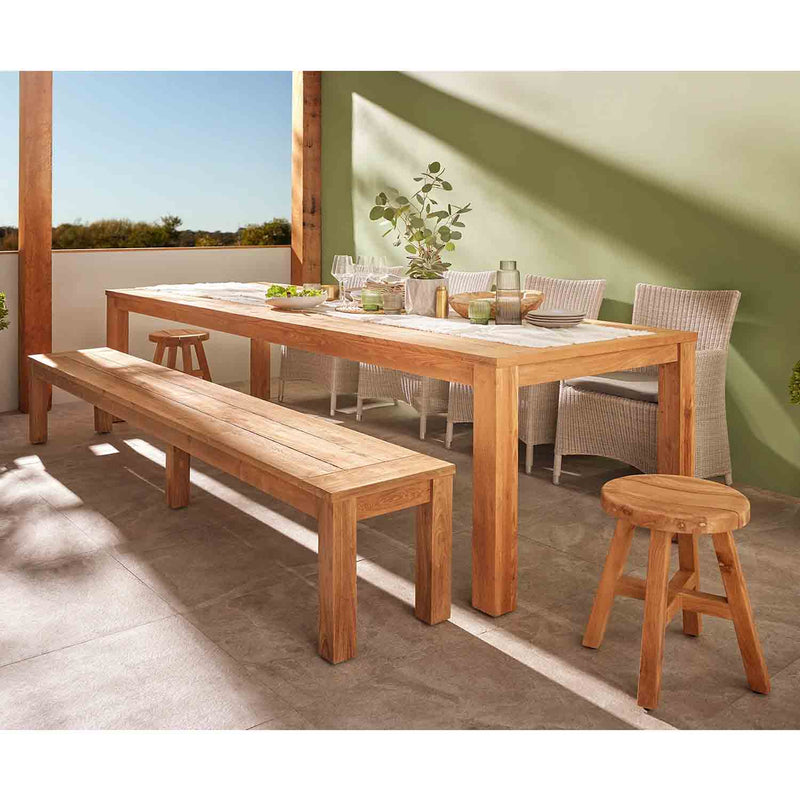 Outdoor furniture: Polly dining table made from FSC-certified recycled teak, natural finish, set against a green wall.