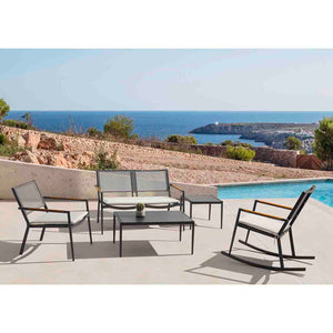 Aluminium patio chairs, including a leisure chair, a two-seater lounge, and a rocking chair, are arranged around a sleek outdoor coffee table with a ceramic glass top. An additional coffee table is placed beside the lounge for added functionality. This stylish alfresco furniture set is positioned poolside in the outdoor area of a modern European home.