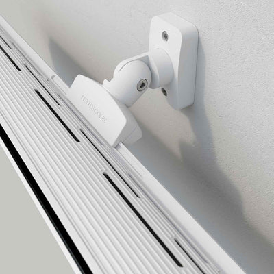 Close-up of the back attachment part of a white Heatscope Outdoor Pure+ heater mounted on a white wall, designed for efficient outdoor heating in stylish living spaces.
