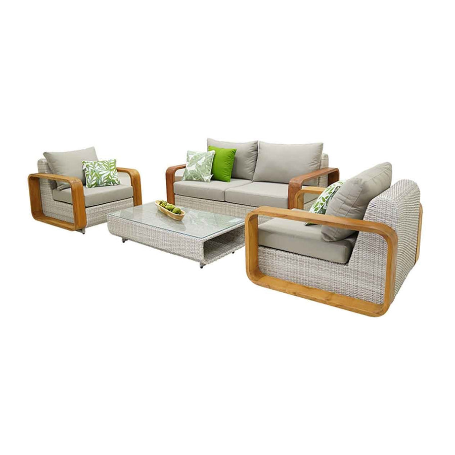 A modern 4 seater outdoor wicker lounge in a neutral beige fabric is set against a plain white backdrop & viewed from an angle. The outdoor furniture features clean lines, plush cushions, and a wooden frame, exuding contemporary elegance and comfort.