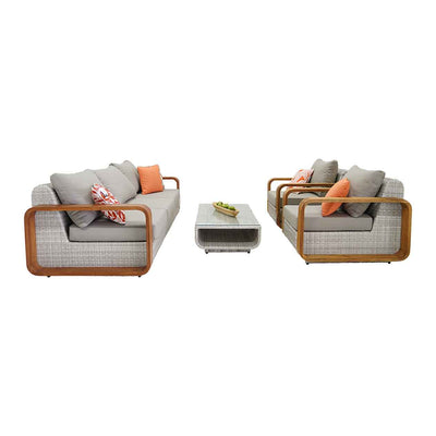 Rossland outdoor lounge collection featuring a wicker lounge chair, 2-seater, 3-seater, 4-seater and 5-seater sofas with teak arms and orange pillows, set in a serene outdoor oasis.