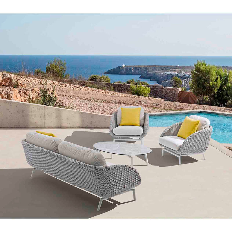 Sorrento 5-seater outdoor lounge setting with yellow pillows on each seat and a matching coffee table, set poolside in a modern outdoor area, with the sun beaming in, showcasing vibrant alfresco furniture.