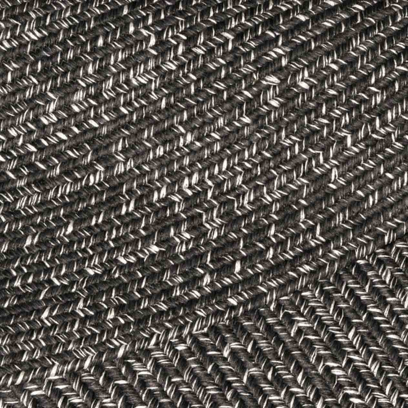 Extreme close-up of a black rug, revealing detailed pattern, ideal for outdoor furniture setups.