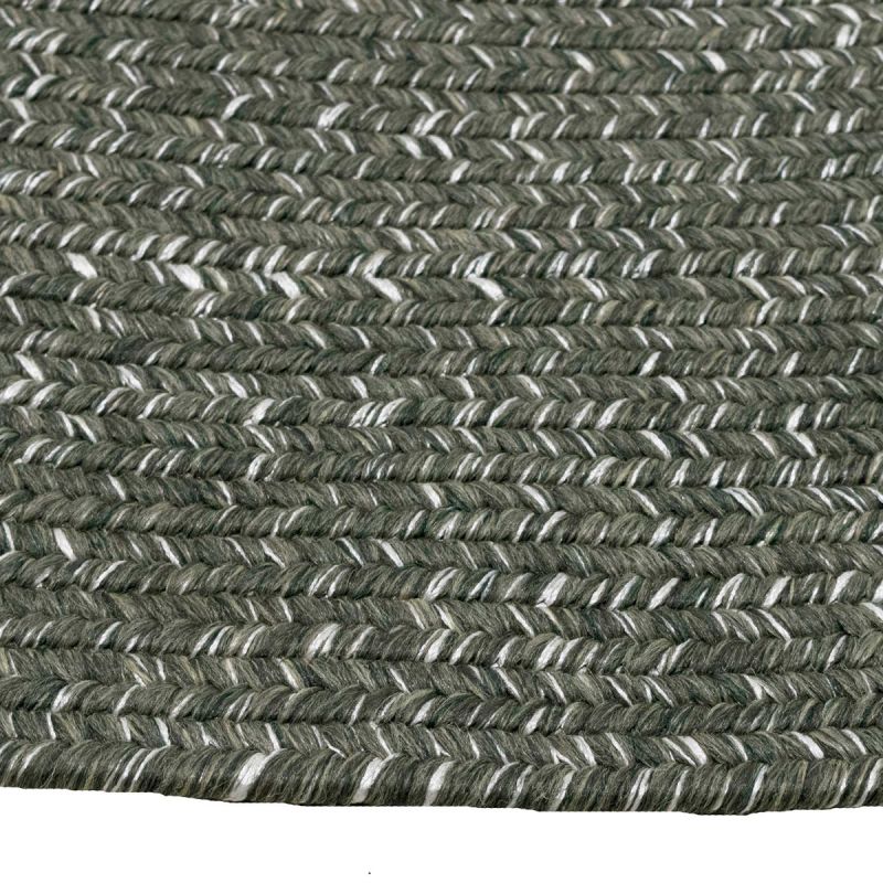 Extreme close-up of a dark-grey round rug, highlighting intricate pattern, set against a plain white background.
