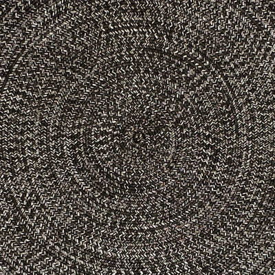 Close-up of a black round rug, highlighting the circular pattern, perfect for outdoor furniture setups.