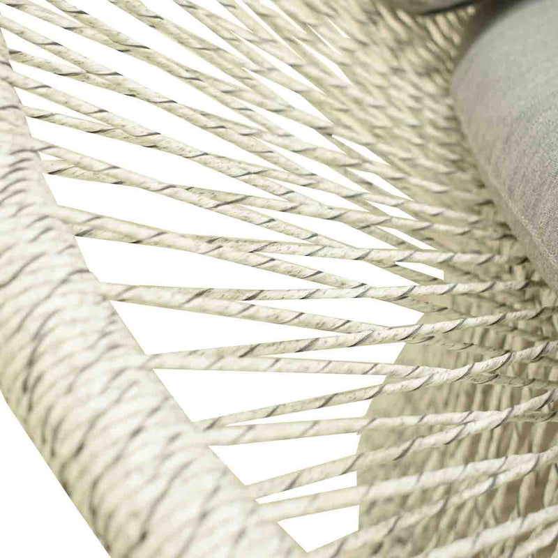 Close up on the wicker design & upholstery of a white & grey wicker outdoor wicker lounge from the &