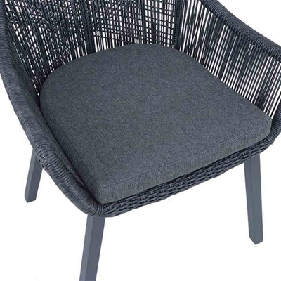 Close-up on the seat cushion of a black String wicker outdoor chair, perfect for alfresco furniture setups, displayed on a plain white background.