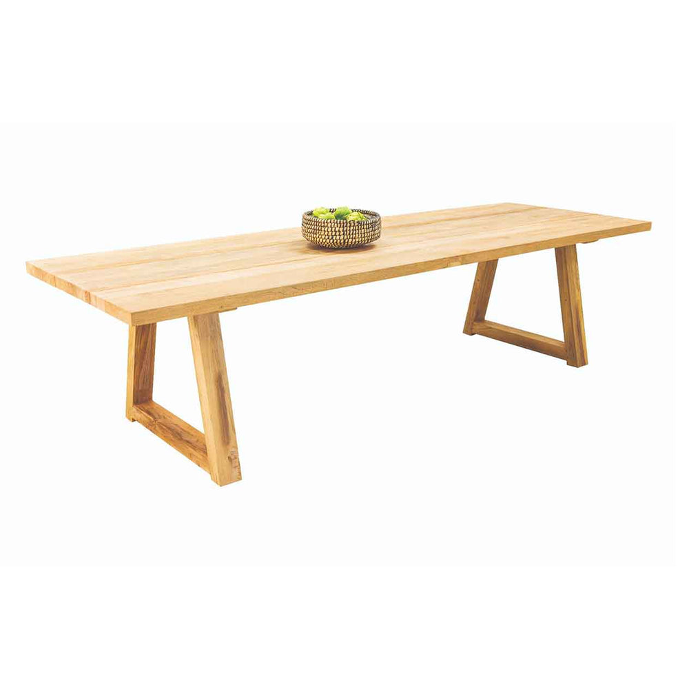 Outdoor furniture: A recycled teak dining table with natural frame with a basket of fruits set against a white background.