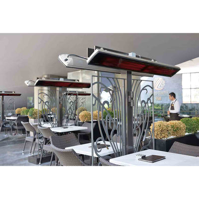 A series of Heatscope Outdoor Vision 3200W heaters mounted above each table in an outdoor restaurant, ensuring customers enjoy warmth while dining in an outdoor living space.