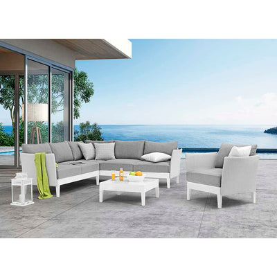 White and light grey Belfast Outdoor Aluminium Armchair, 6 Seater Outdoor Aluminium Lounge, and Square Coffee Table set by the water in an outdoor area of a modern house, creating a stylish outdoor living space perfect for relaxation.