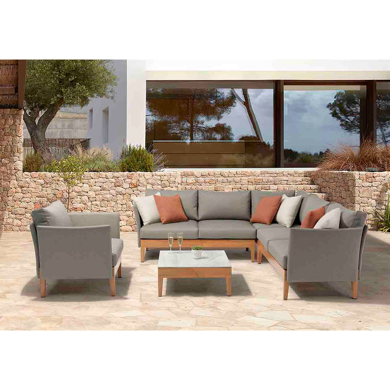 Grey & brown Belfast Outdoor Armchair, 6 Seater Outdoor Lounge, and Square Coffee Table set on an outdoor area of a modern house, creating a stylish outdoor living space perfect for relaxation.