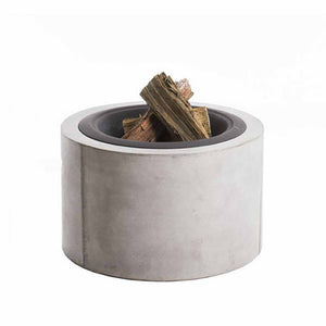 A round fire pit with a concrete frame and steel base. Inside, small pieces of wood are placed. The fire pit is set against a plain white background. It's small & compact; making it a perfect addition to any outdoor furniture setup.