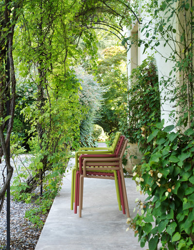 Designer Raffaello Galiotto's Doga Range of Outdoor Furniture, featuring vibrant Outdoor Chairs with and without armrests.