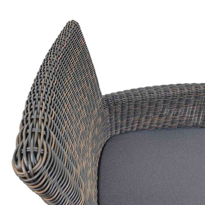 A close-up view of a wicker dining chair with charcoal frame and dark grey fabric set against a white background. Outdoor furniture, outdoor chairs, outdoor balcony furniture.