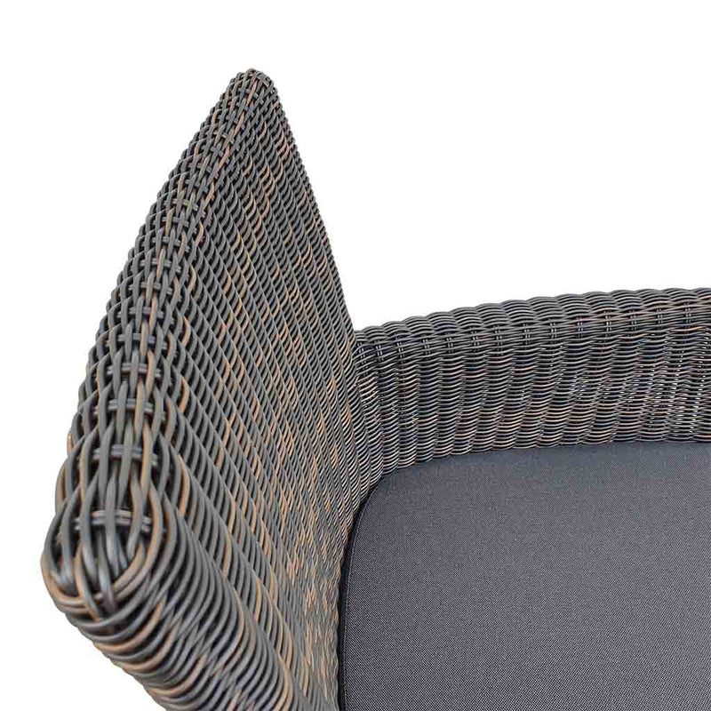 A close-up view of a wicker dining chair with charcoal frame and dark grey fabric set against a white background. Outdoor furniture, outdoor chairs, outdoor balcony furniture.