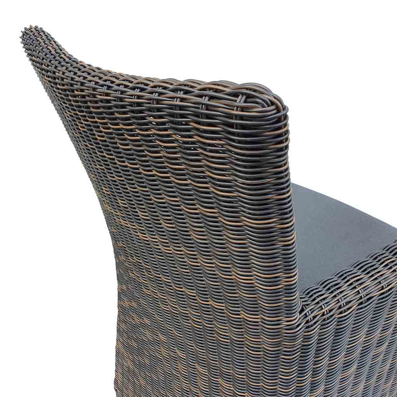 Outdoor furniture: A back view of a wicker dining chair with charcoal frame and dark grey fabric set against a white background. Outdoor chairs, outdoor balcony furniture.