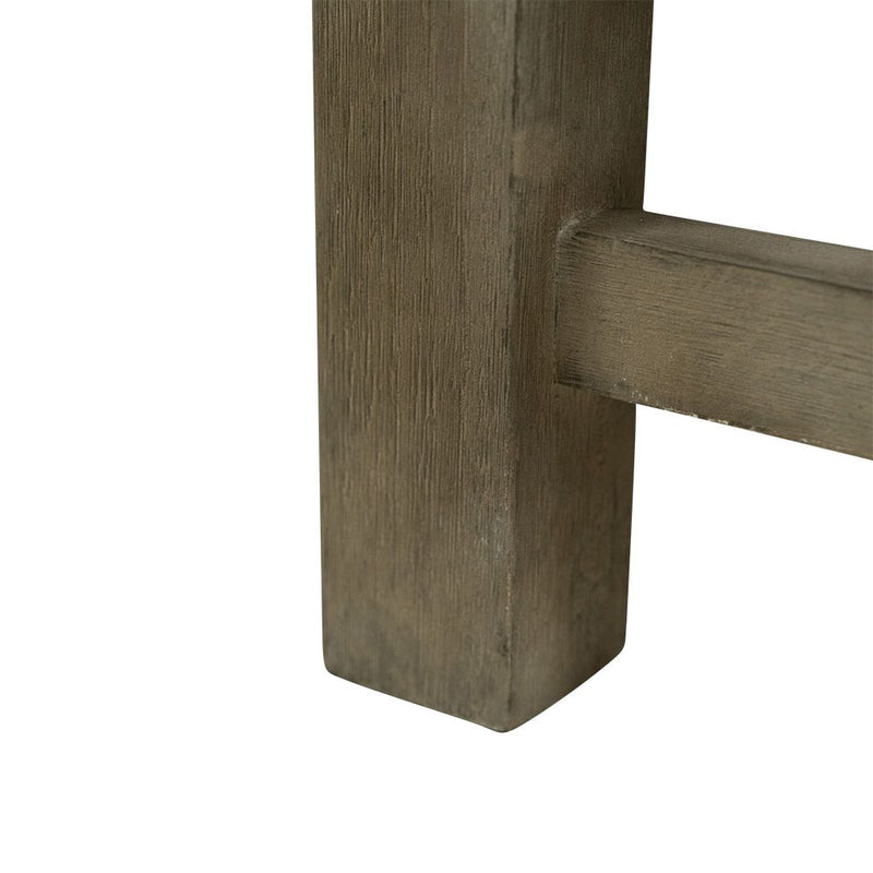 A close-up on the leg of a 150cm dark brown wooden outdoor bench. The bench is made of high-quality acacia wood, and perfect for any outdoor setting. It is displayed on a plain white background.