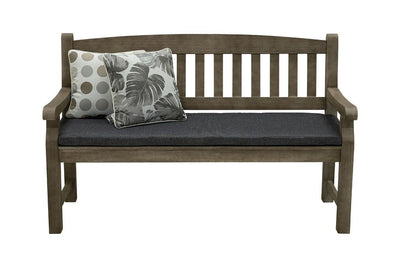 A 150cm dark brown wooden outdoor bench with a dark grey fade-resistant seat cushion & 2 light-coloured decorative throw pillows. The bench is made of high-quality acacia wood, and perfect for any outdoor setting. It is displayed on a plain white background, viewed from the front.