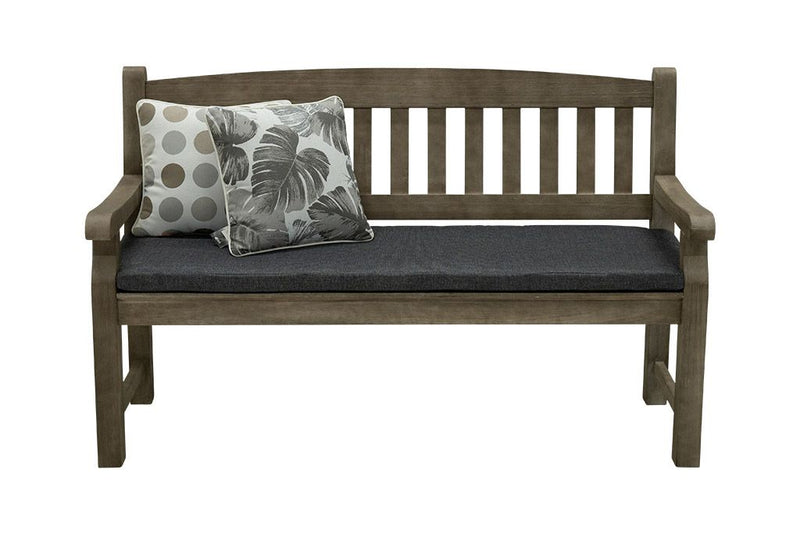A 150cm dark brown wooden outdoor bench with a dark grey fade-resistant seat cushion & 2 light-coloured decorative throw pillows. The bench is made of high-quality acacia wood, and perfect for any outdoor setting. It is displayed on a plain white background, viewed from the front.