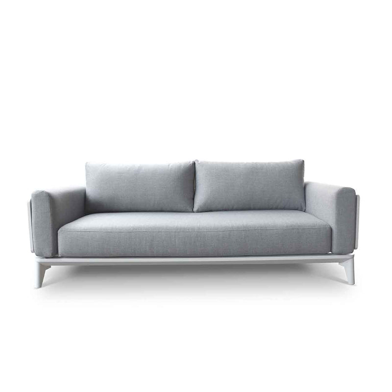 Alora range aluminum outdoor furniture, including a comfy 1-seater and 5-seater outdoor lounge chair, displayed on a grey couch with pillows on a white background.